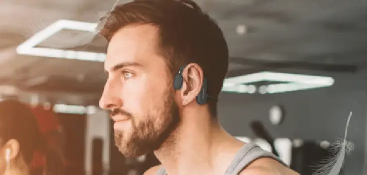 Man enjoying music using Inductivv headphones while staying alert to their surroundings.